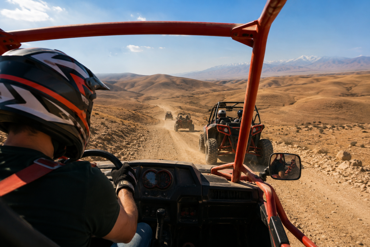 Driver enjoying a one-hour buggy ride through the Agafay Desert with Atlas Mountains in the distance